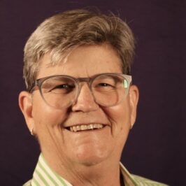 woman with gray hair and glasses