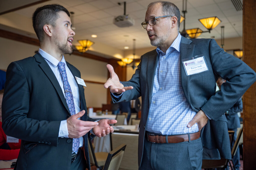 A Nicholas Center board member speaks with an MBA student.