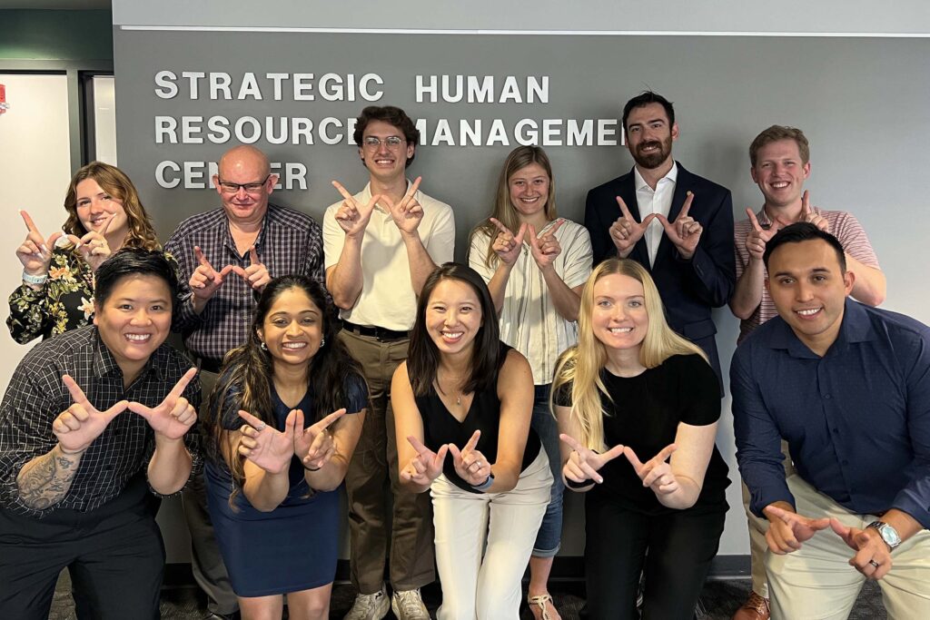 SHR students and graduates throw up Wisconsin's "W" at a mock interview workshop