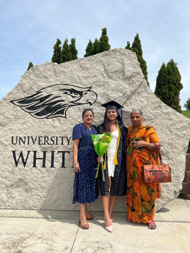 Richa standing with family at UW Whitewater graduation