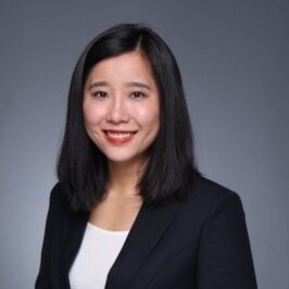 woman with dark hair wearing a blazer
