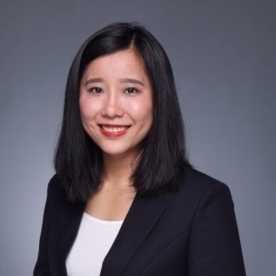woman with dark hair wearing a blazer