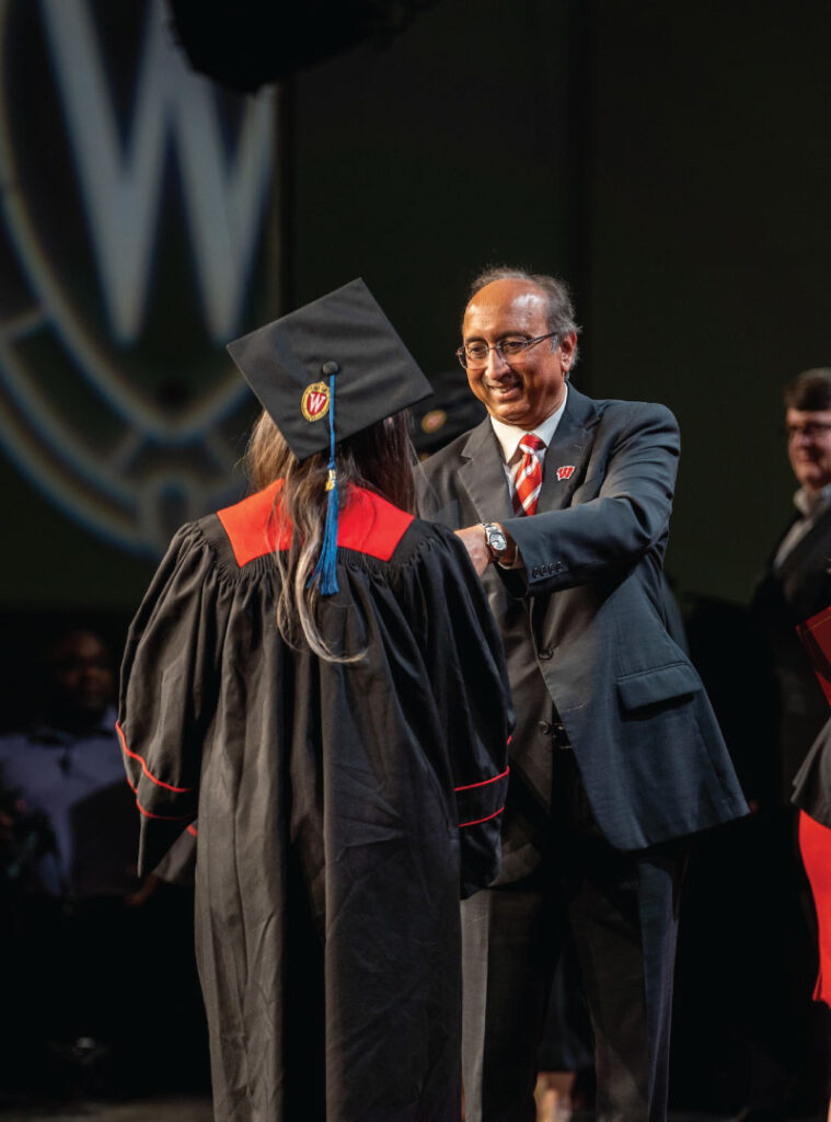 A graduate is greeted by Dean Vallabh “Samba” Sambamurthy onstage at commencement.