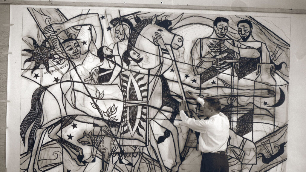 Artist James Watrous stands in front of a draft for his mosaic, Ancient Commerce, in the Commerce Building.