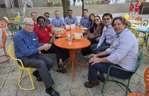 Some students, faculty, and staff of the RMI MBA program relax on the Memorial Union Terrace with some program alumni.