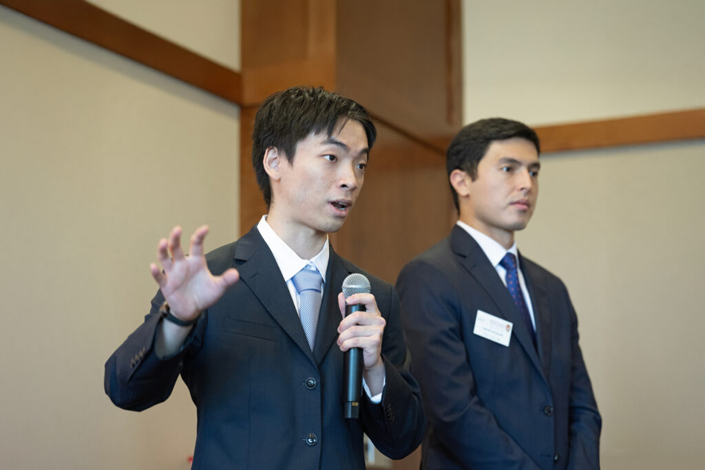 Two students present their group project to an audience.