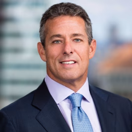 Man with gray hair in a navy suit