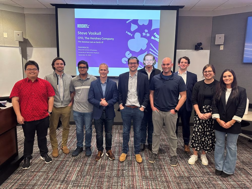 Steve Voskuil CFO, Hersheys stands with group of MBA students