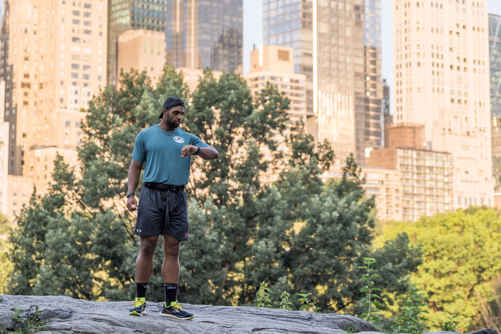 Bryson out on a run outside, pausing to check his watch.