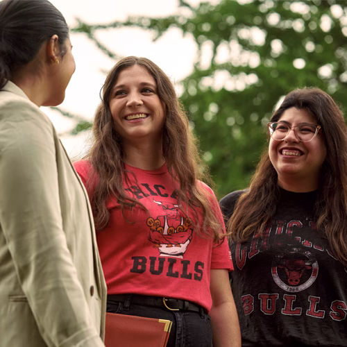 Abbe smiling with her coworkers in a Chicago Bulls t-shirt.