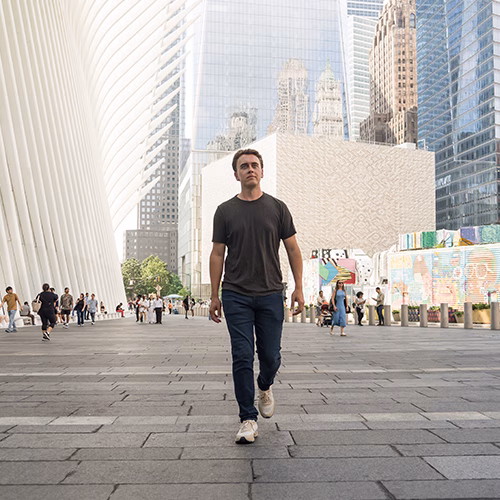Anders walking down a busy city sidewalk.