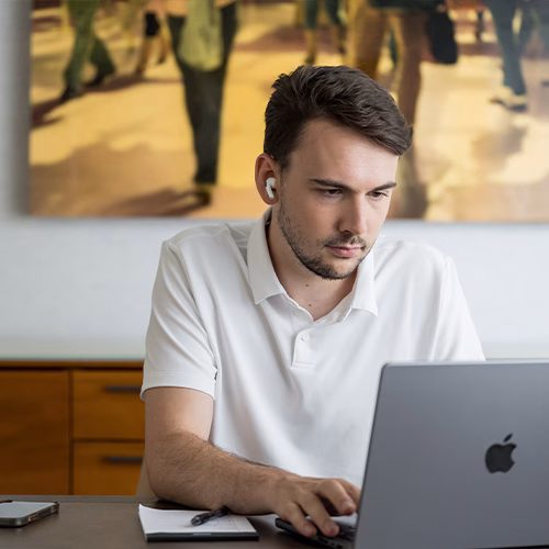 Charlie focused on his laptop as he works.