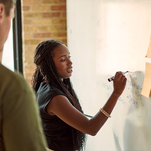 Oumou writing on a board.