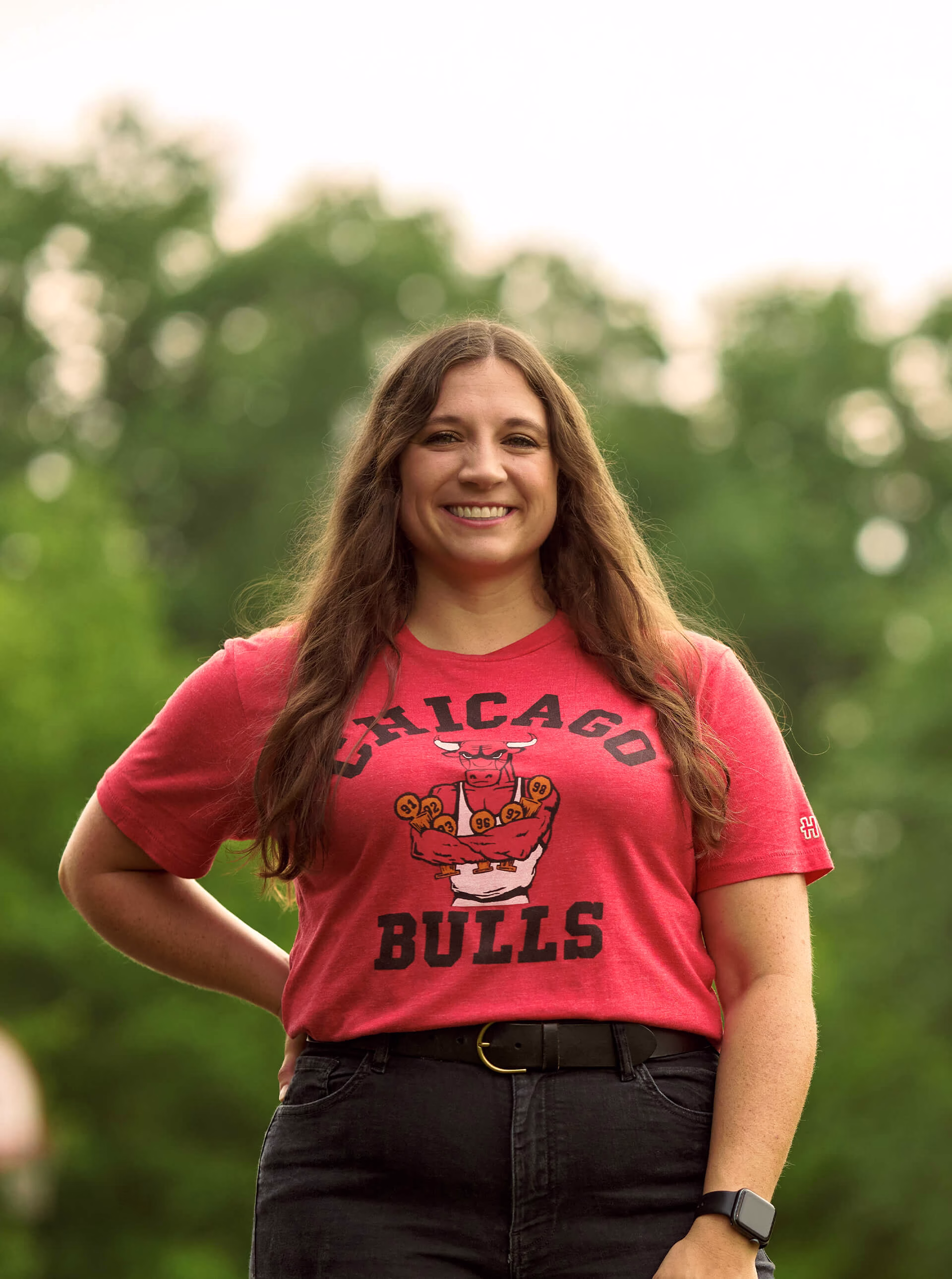 Abbe smiling confidently wearing a Chicago Bulls t-shirt.