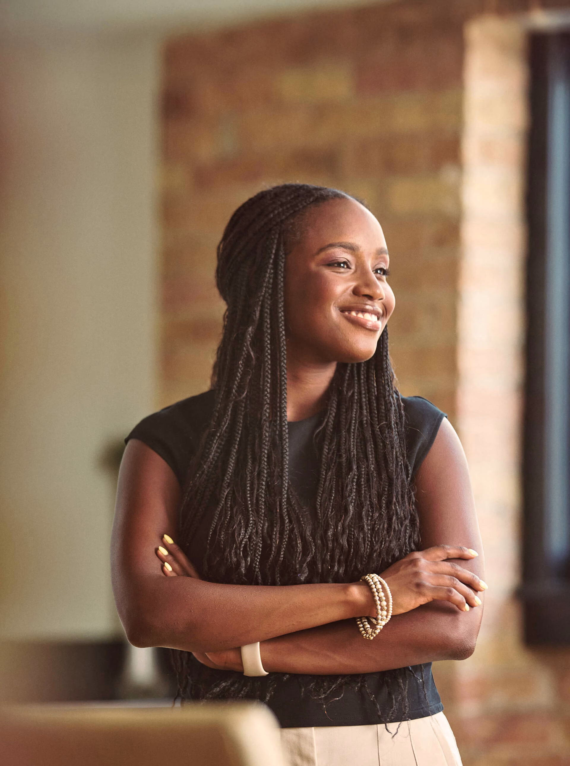 Oumou smiling into the distance.