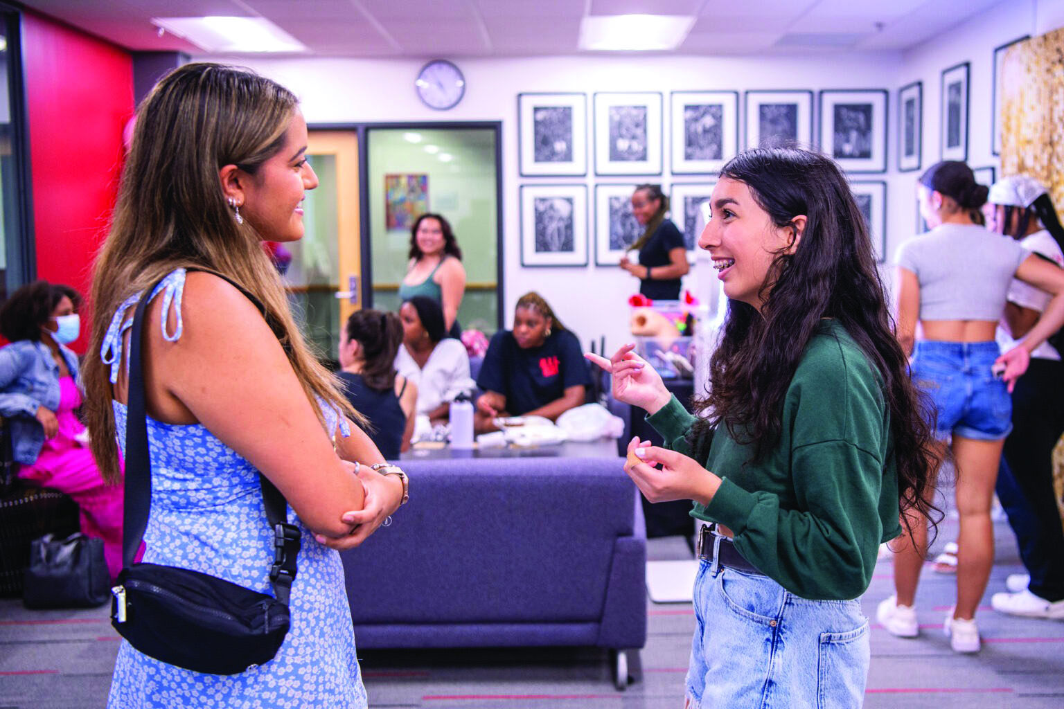 Two students stand and talk inside WSB's Multicultural Center.
