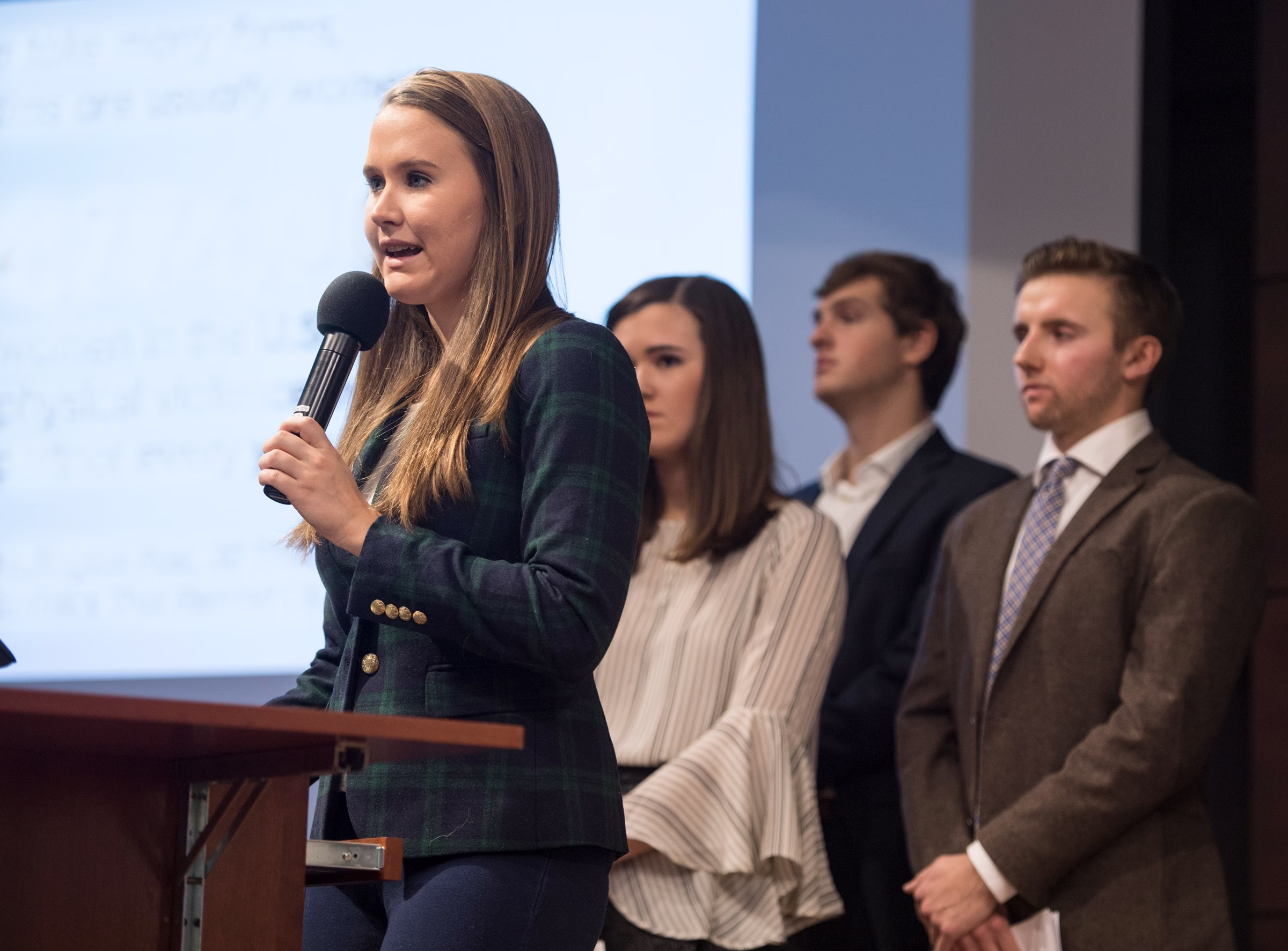 A woman speaking at a podium.