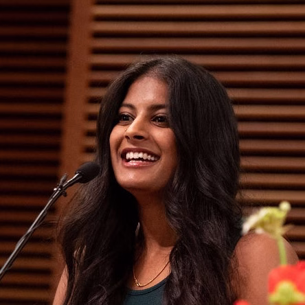 Ambika speaking at graduation.