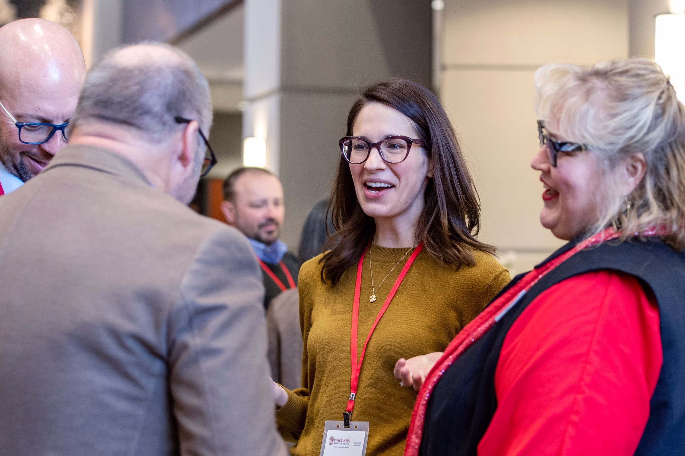 Two women and two men talking at an event.