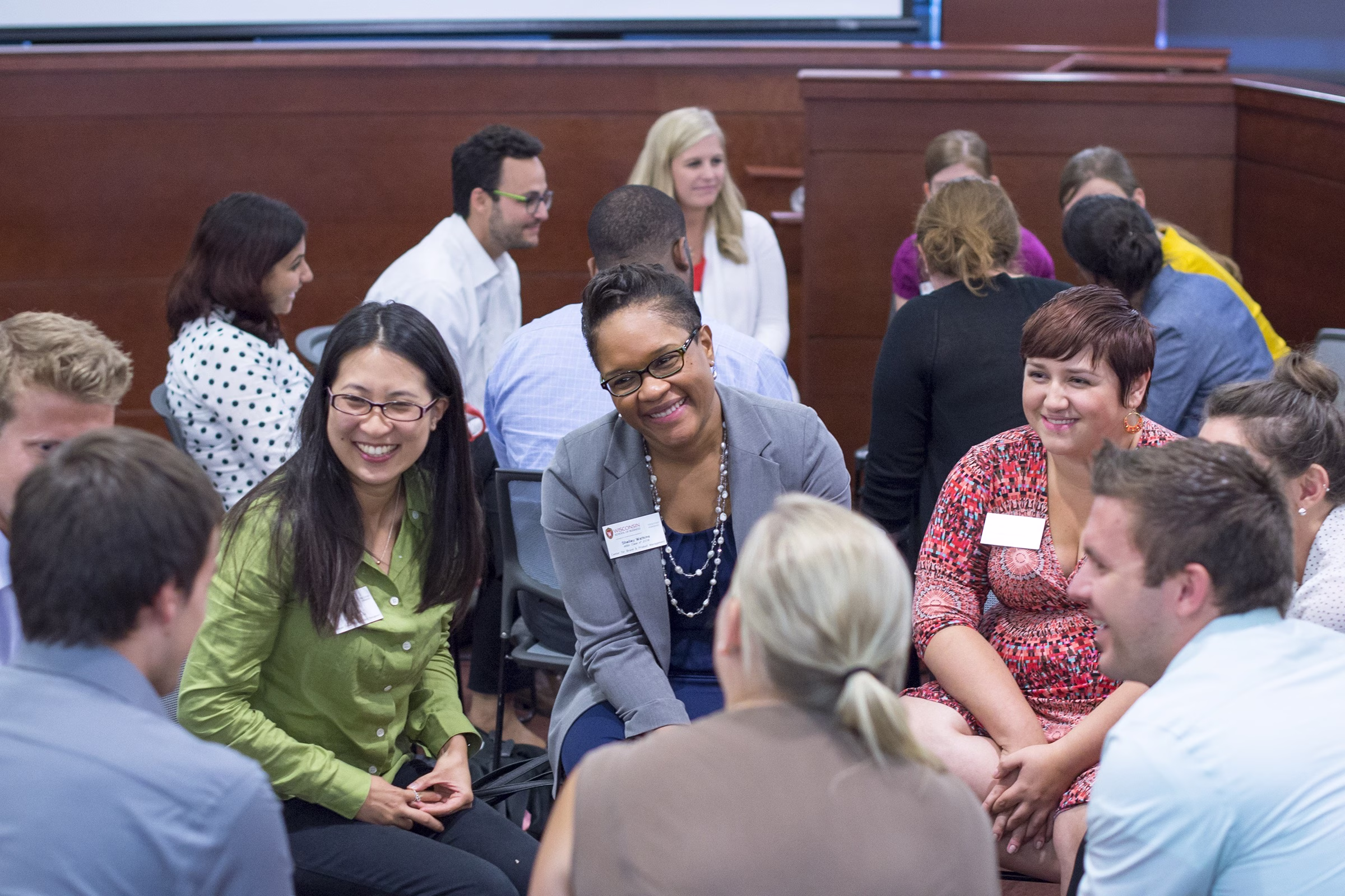 A group of people sitting in a circle having a discussion.