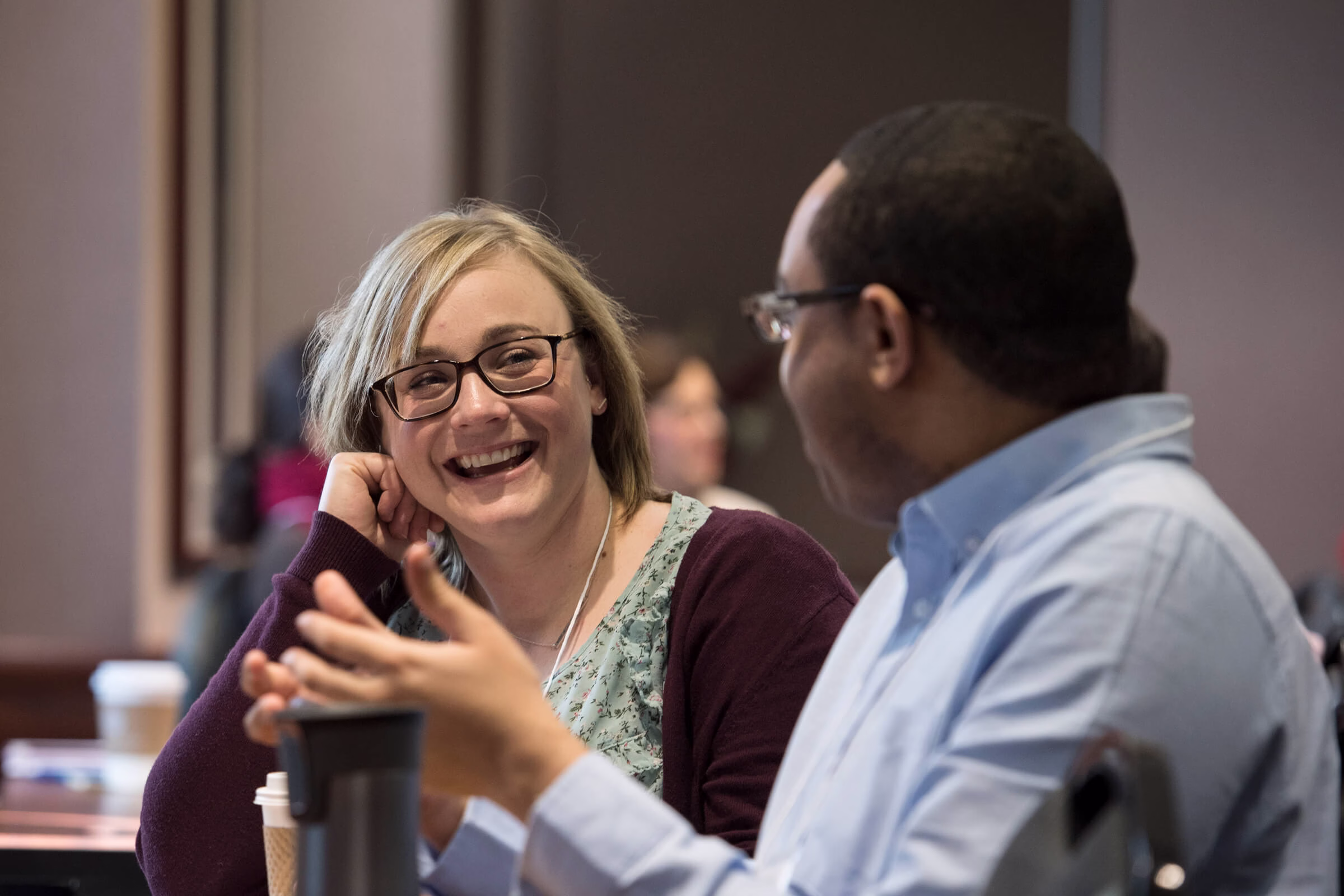 A man and woman sitting and laughing.