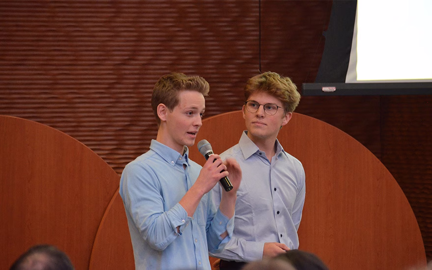 Students explaining their pitch into microphone.