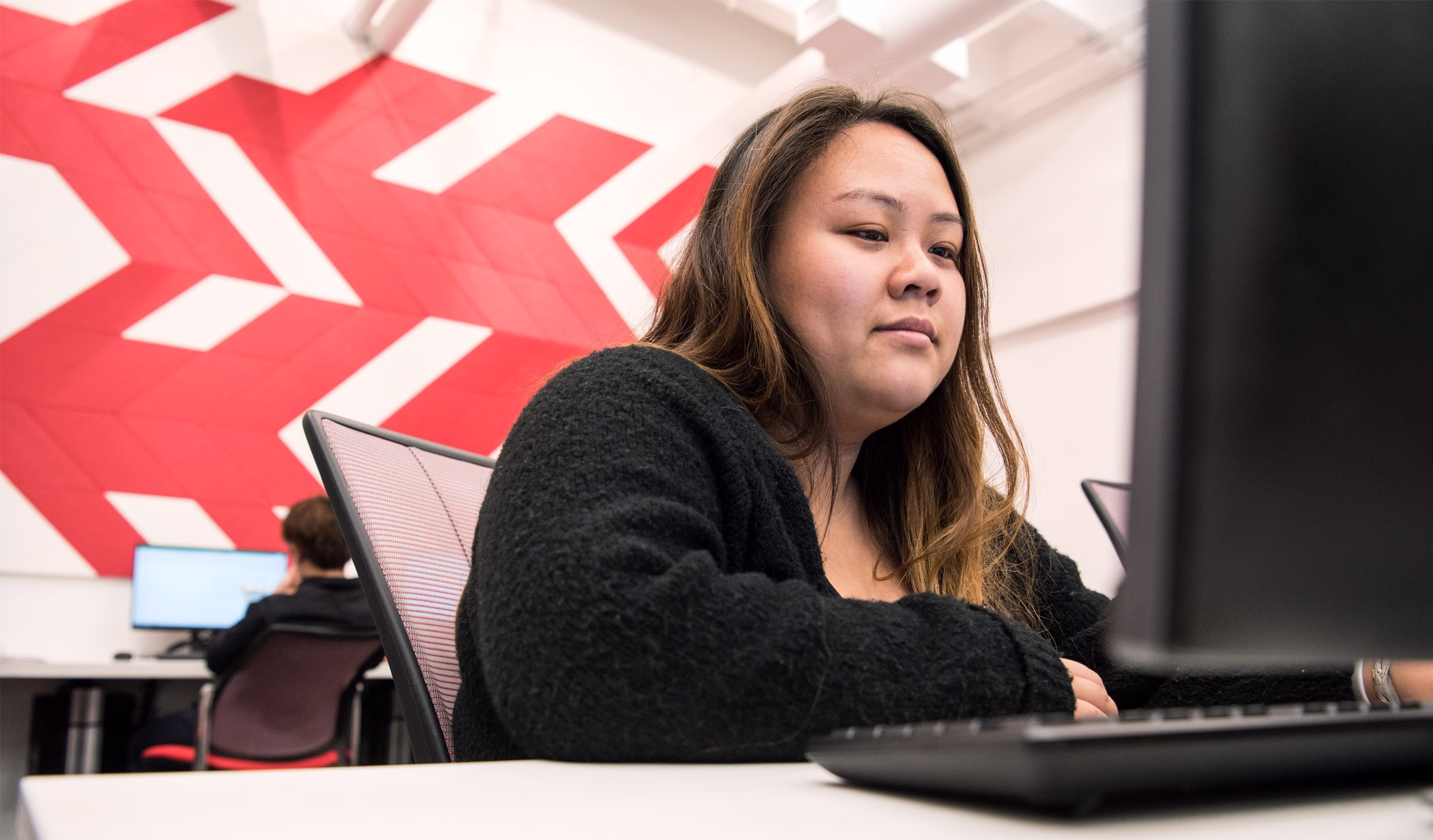 woman sitting in front of computer.