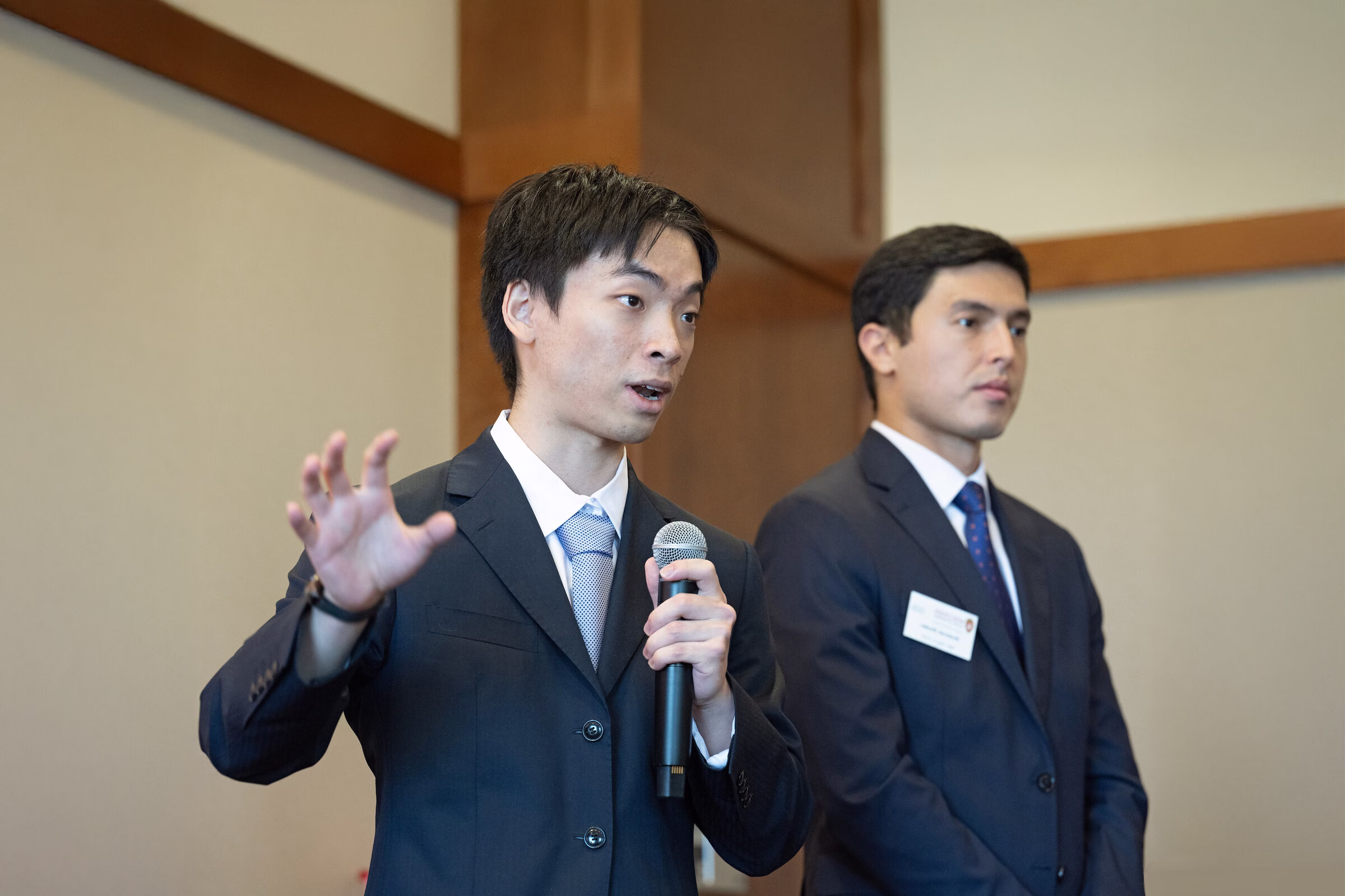 Two students present their group project to an audience.