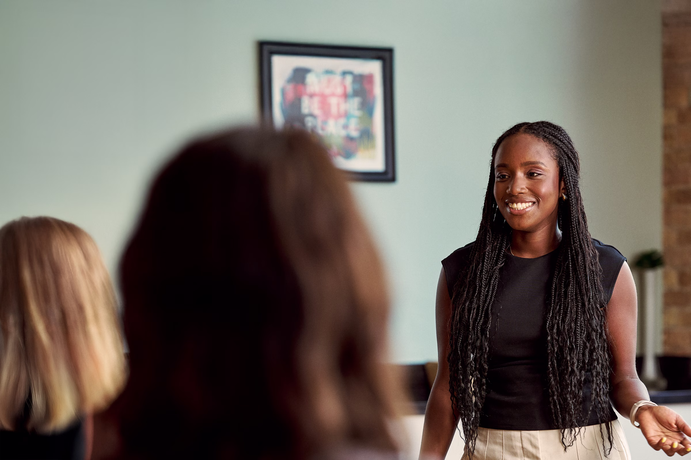 Oumou smiling at her coworkers.