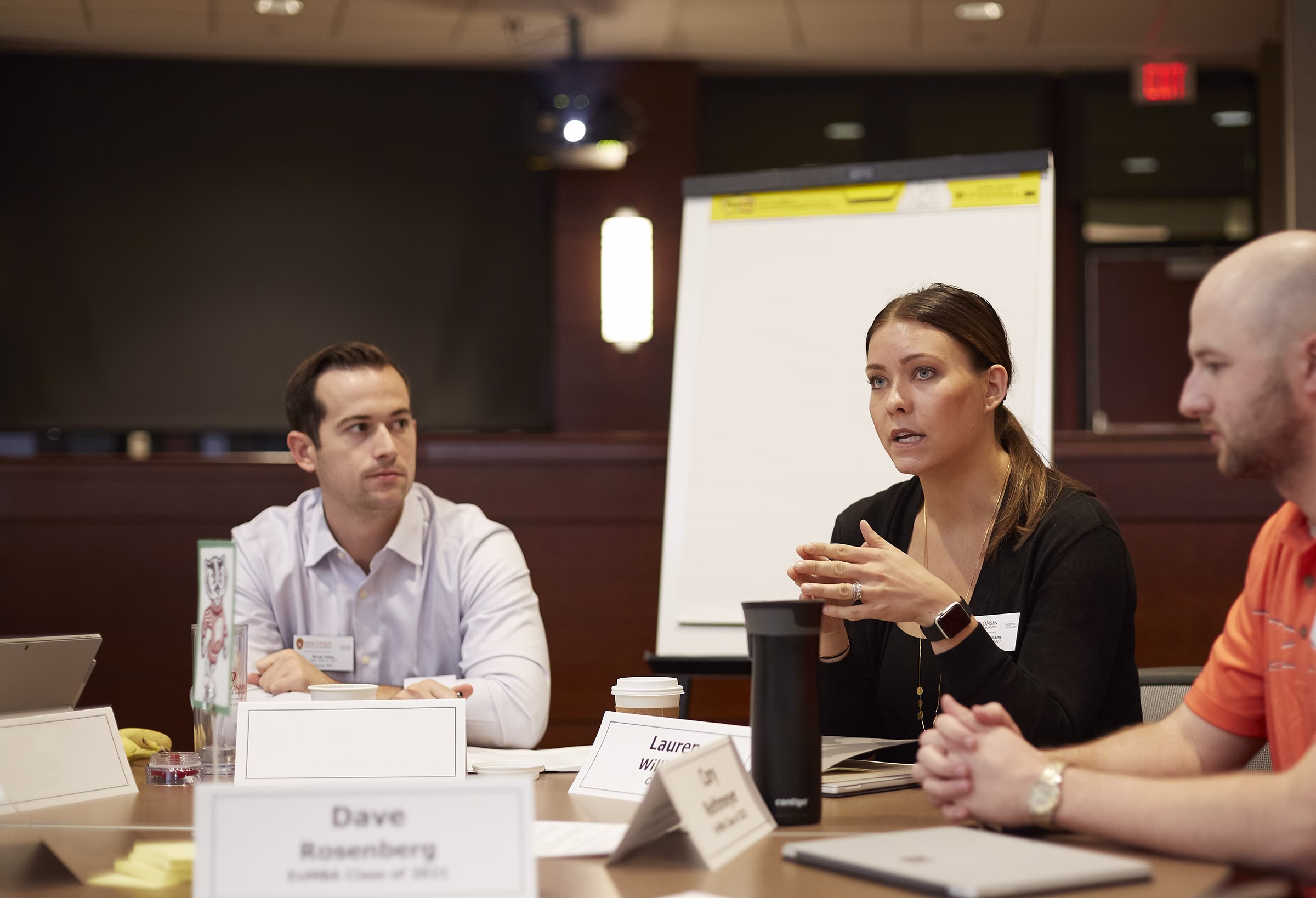 Students talking around table.
