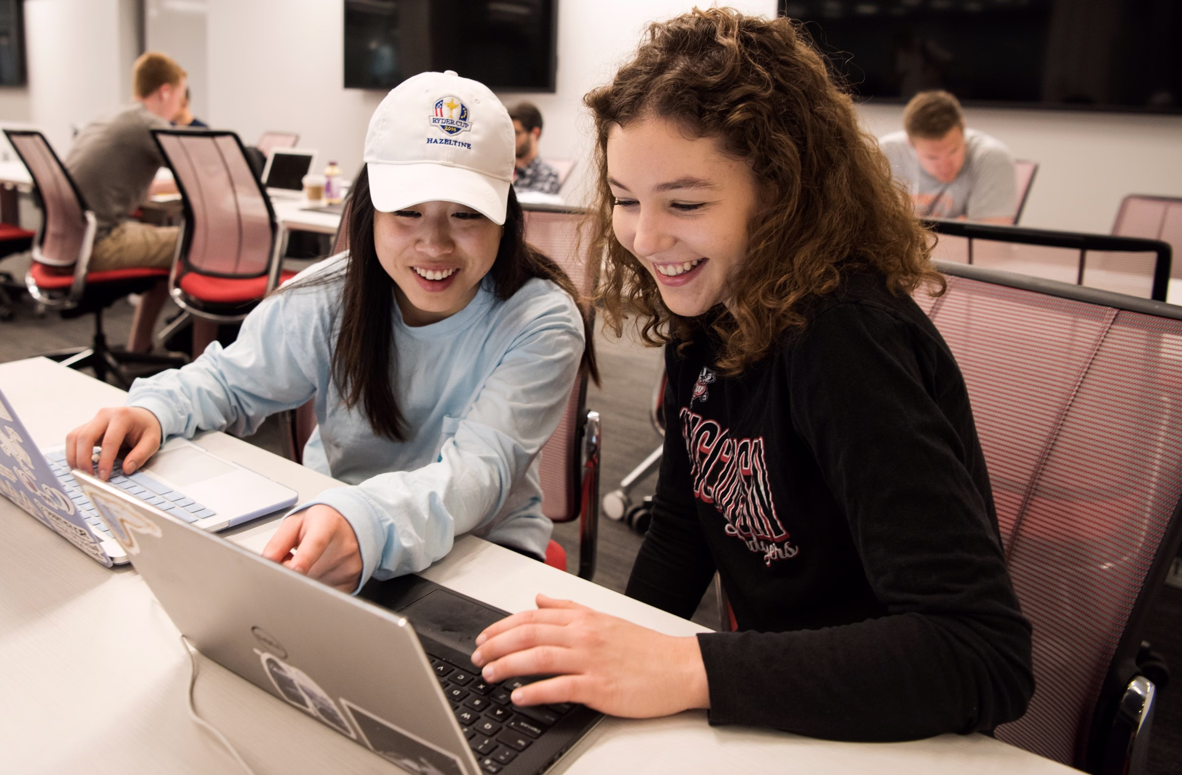 Two women looking at a laptop.