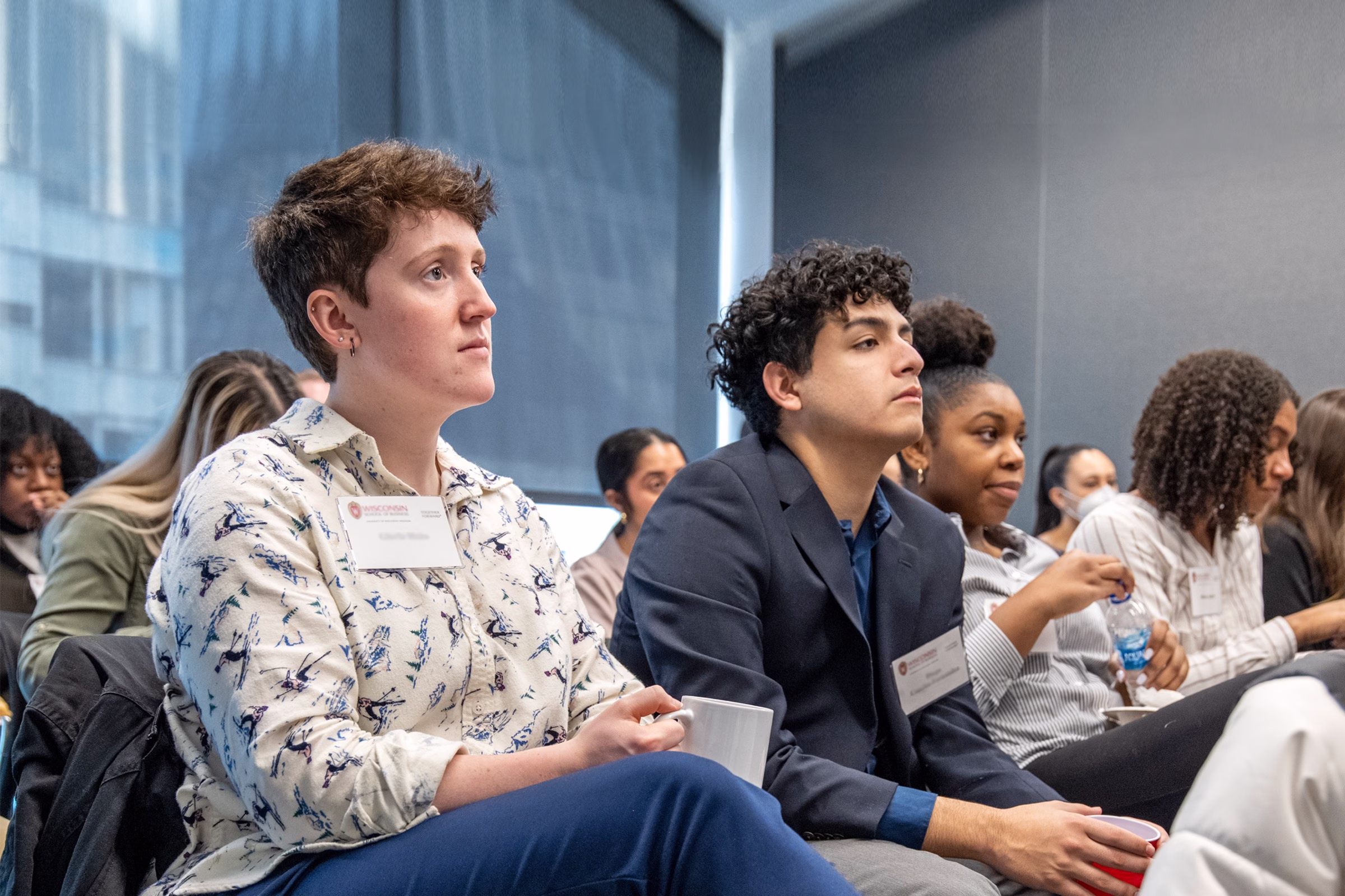 Students sitting in a classroom listening to a speaker.