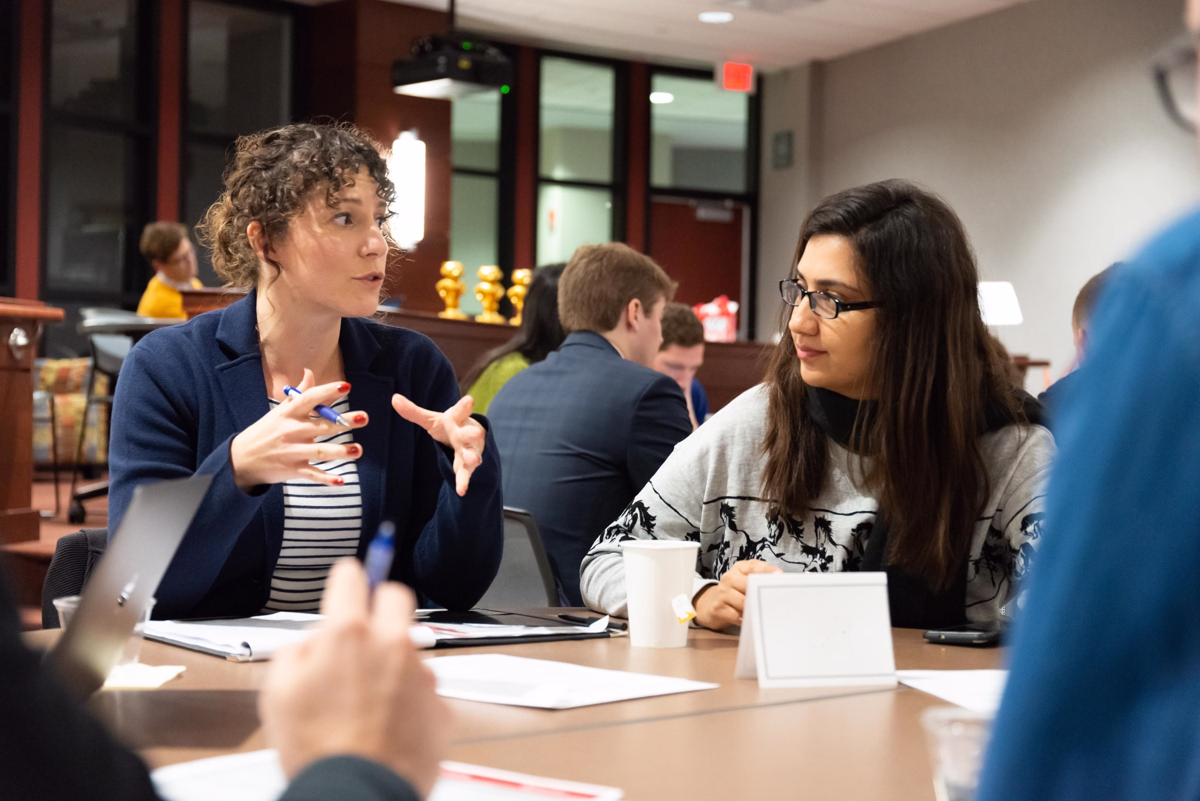 Two women talking at a table.