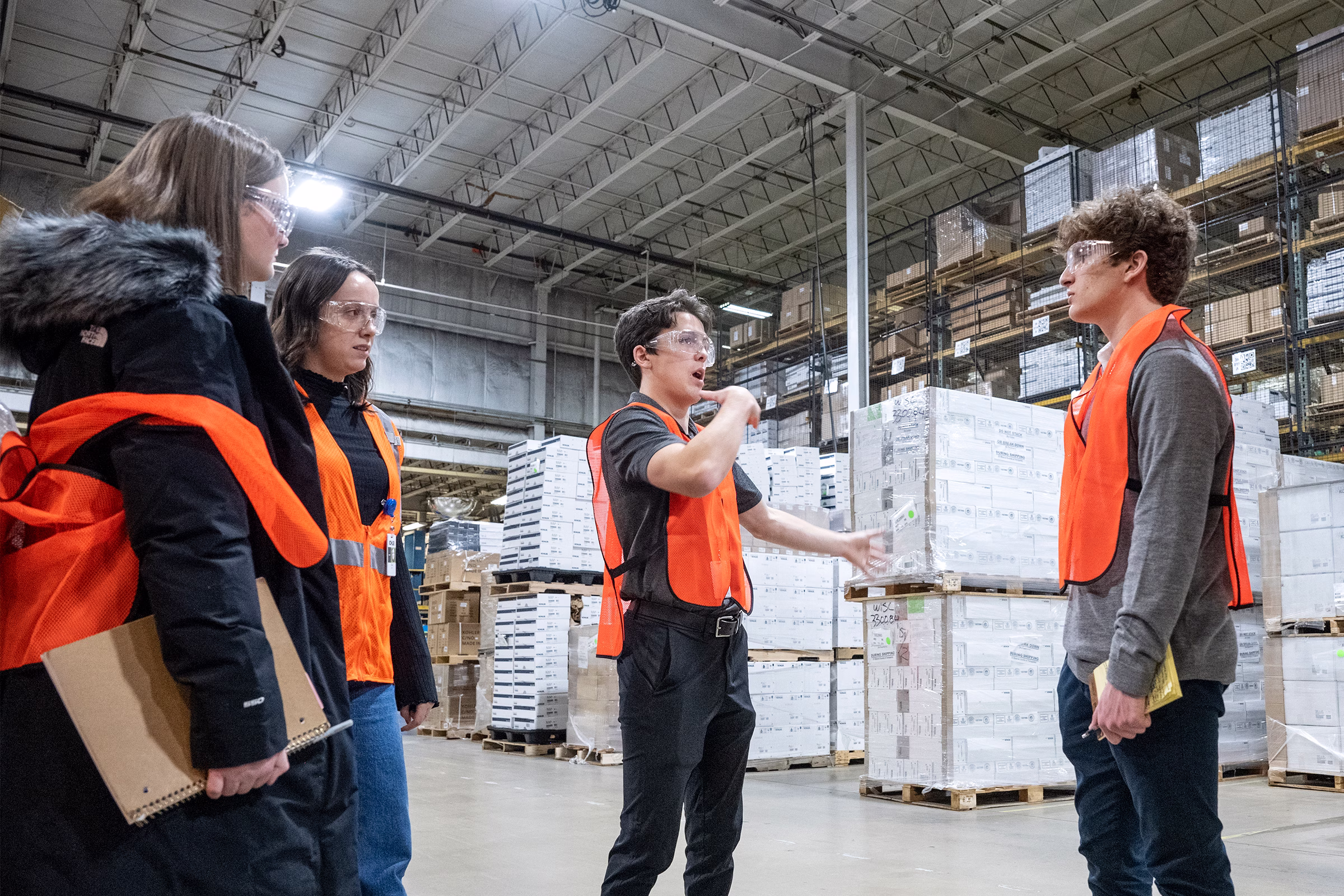 Students tour a warehouse during a company visit to Kohler.