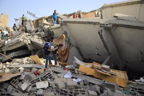 Photo of people standing on an unidentifiably demolished concrete structure