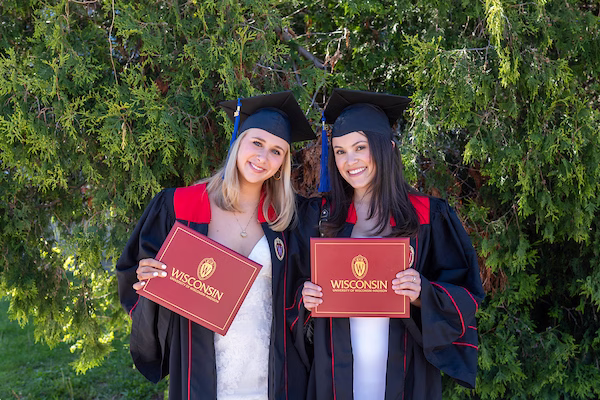 Graduates Renee Marconi and Addyson Farias poses for a photo at the Business School Graduation Event.