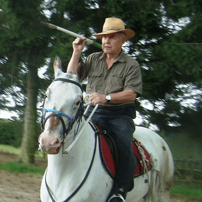 Svend Kraemer riding a horse, aiming a javelin.