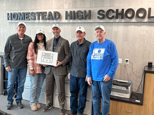Five people standing in front of Homestead High School.