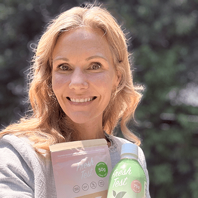 Jacquie Berg Ramsey holding her Fresh Test products.