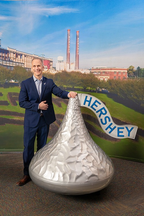 Steve standing next to a giant Hershey's kiss.