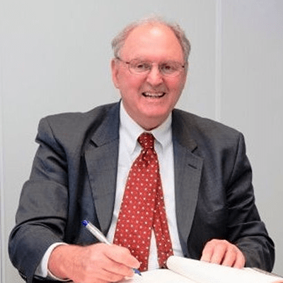 Professor Larry Rittenberg smiling, wearing a suit.