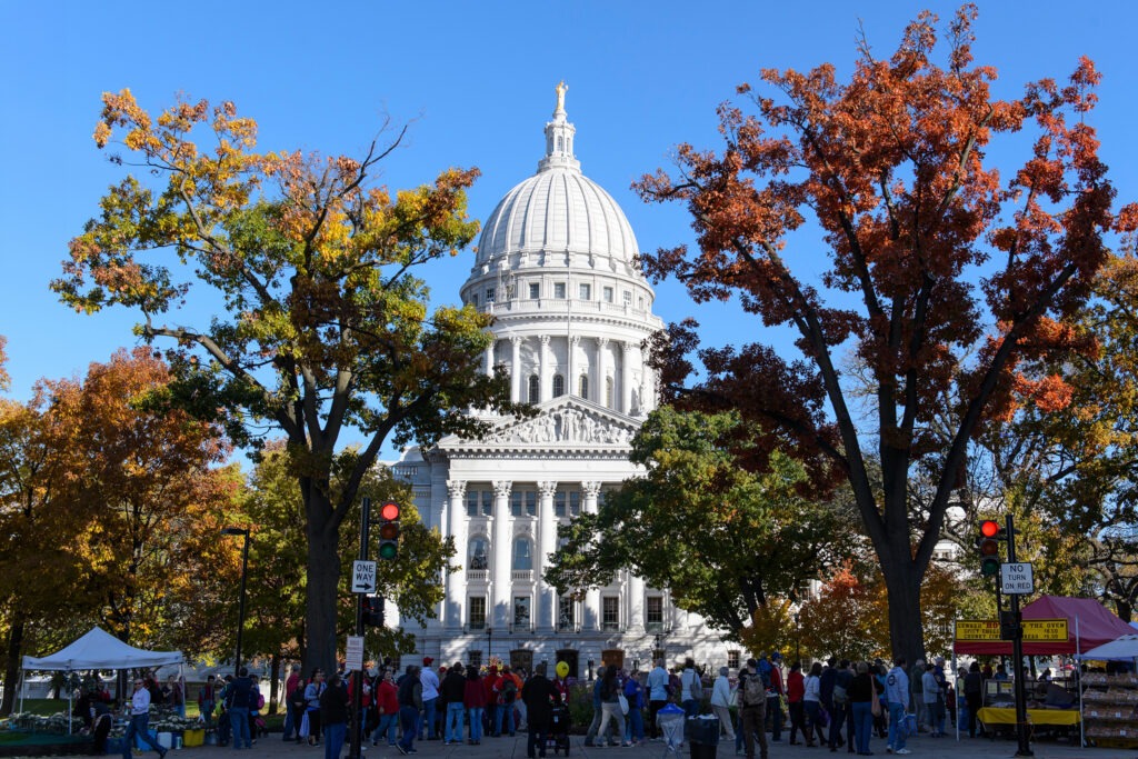 People walking around the farmers at the Capital Building.