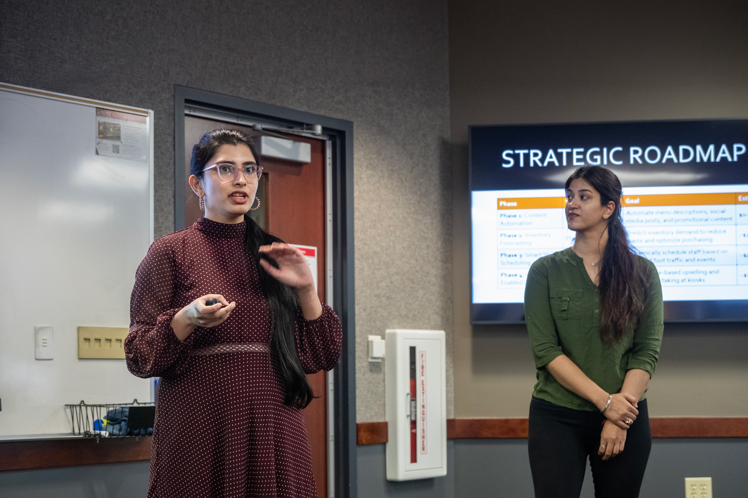Two female students give a presentation.