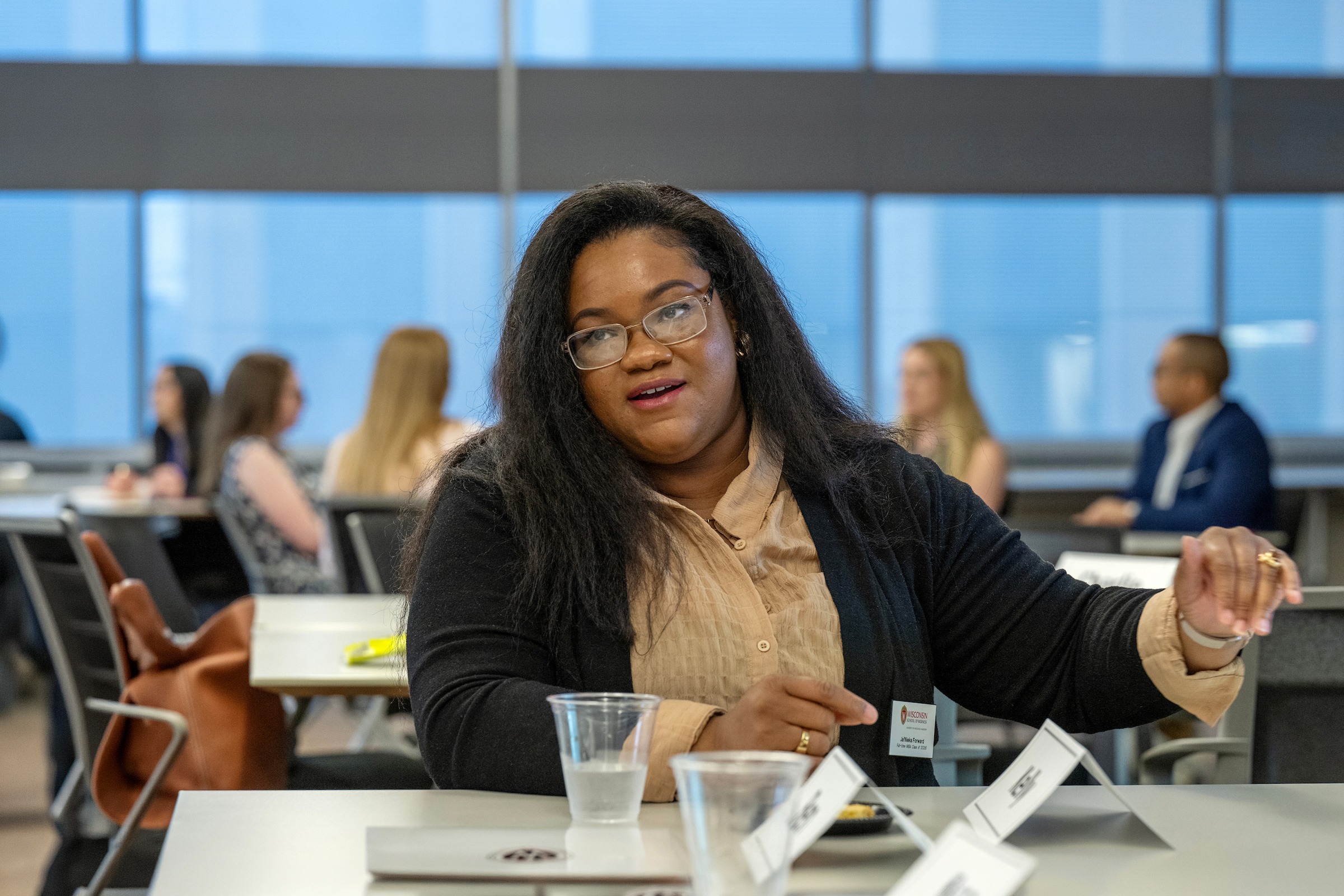 Ja'Nieka Forward talks with other students while sitting at a table.