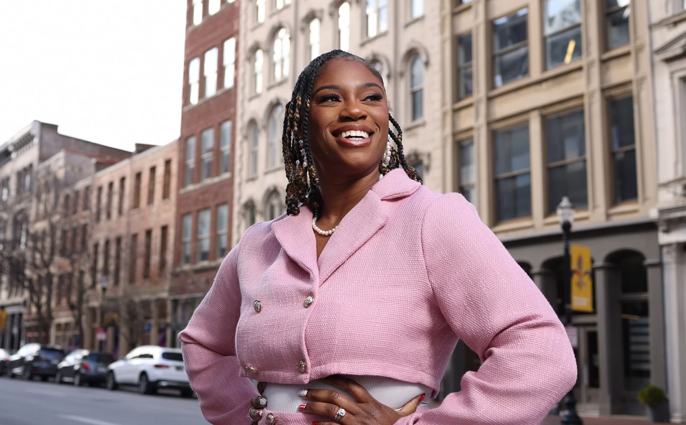 Zena Stephens Joy smiles and stands on the street.