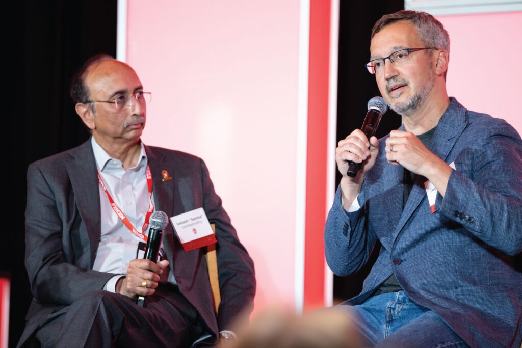 Vallabh Sambamurthy and Remzi Arpaci-Dusseau sit on stage during the Badgers in Tech: Shaping an AI-Driven Future event in Milwaukee.