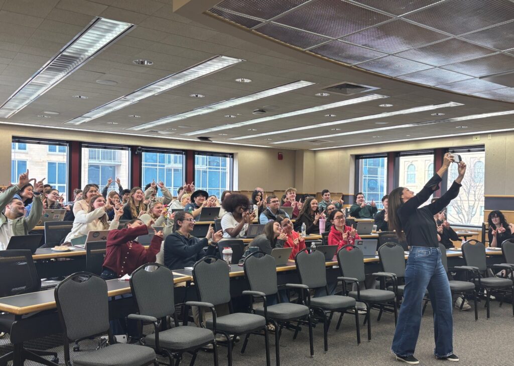 Entrepreneur Natasha takes a selfie with a group of excited students.