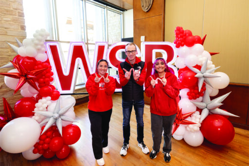 Members of WSB’s Madison BOLD (Badgers of the Last Decade) Circle, including Sarah Maruyama (BBA ’23), Ryan Haehlke (BBA ’15), and Jaqueline Sanchez (BBA ’23) pose in front of a stunning balloon display.