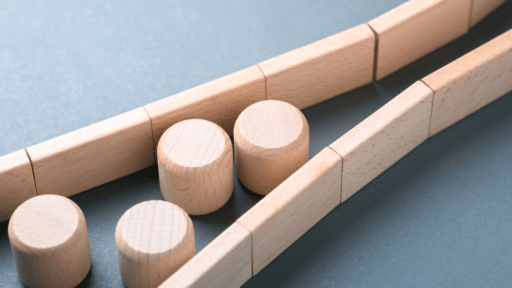 Wooden figurines trying to fits through tight walls