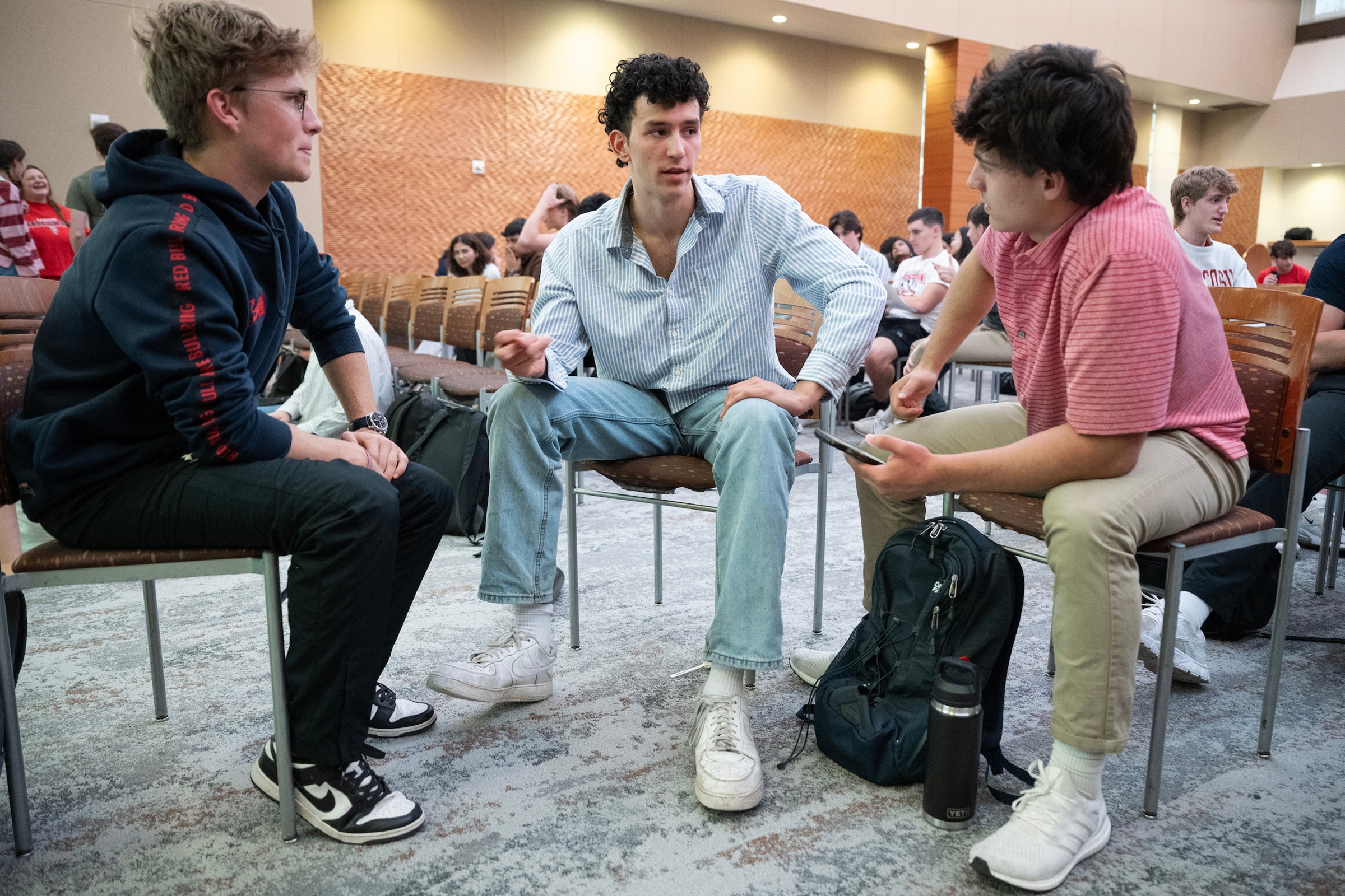 Three students brainstorming together.